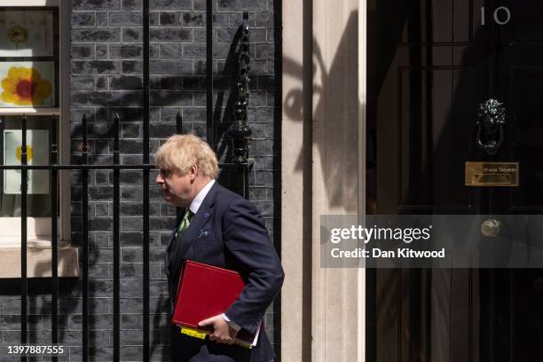 British Prime Minister Boris Johnson leaves 10 Downing Street to attend the weekly Prime Ministers Questions in the House of Commons on May 18, 2022...