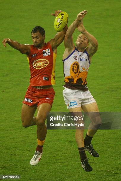 Karmichael Hunt of the Suns and Ryan Harwood of the Lions compete for a mark during the round one NAB Cup AFL match between the Gold Coast Suns and...