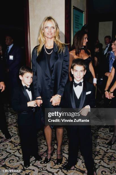 American model and actress Kimberley Conrad and her sons, Marston Hefner and Cooper Hefner attend the presentation of Hefner's Friars Club Lifetime...