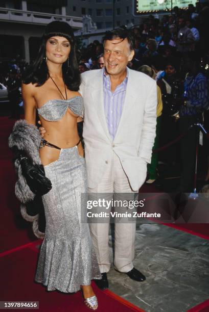 Canadian actress and model Carrie Leigh and her partner, American magazine publisher Hugh Hefner attend the Hollywood premiere of 'Beverly Hills Cop...