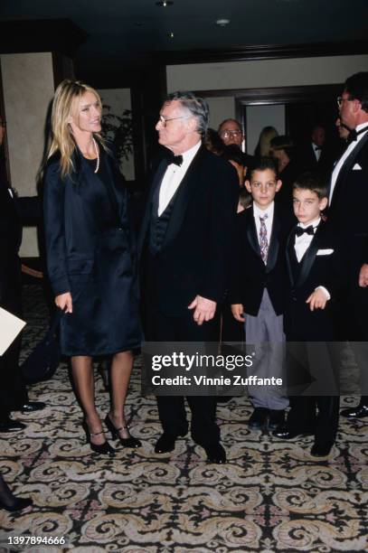 American magazine publisher Hugh Hefner and his wife, America model and actress Kimberley Conrad and their son, Marston Hefner with a child in grey...