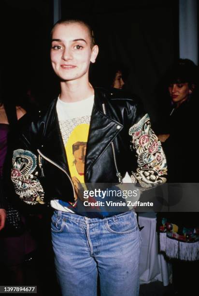Irish singer-songwriter Sinead O'Connor, wearing a black leather jacket over a t-shirt with an image of a praying Virgin Mary, attends the 31st...