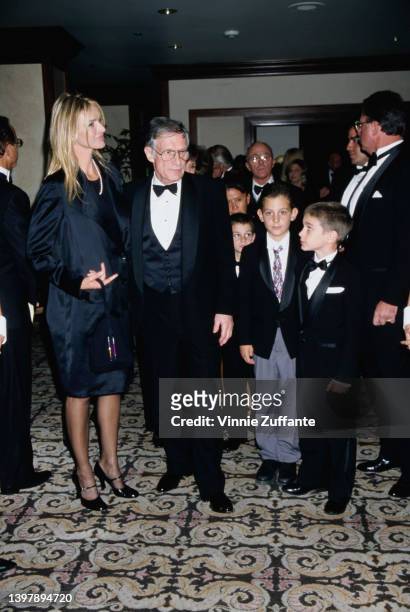 American magazine publisher Hugh Hefner and his wife, America model and actress Kimberley Conrad and their son, Marston Hefner with a child in grey...