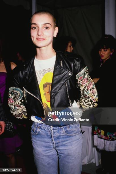 Irish singer-songwriter Sinead O'Connor, wearing a black leather jacket over a t-shirt with an image of a praying Virgin Mary, attends the 31st...