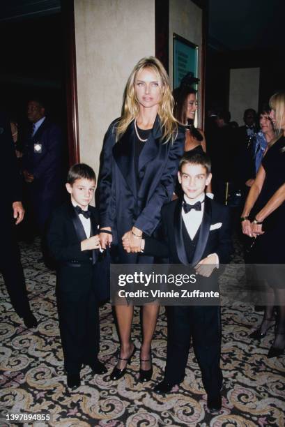 American model and actress Kimberley Conrad and her sons, Marston Hefner and Cooper Hefner attend the presentation of Hefner's Friars Club Lifetime...