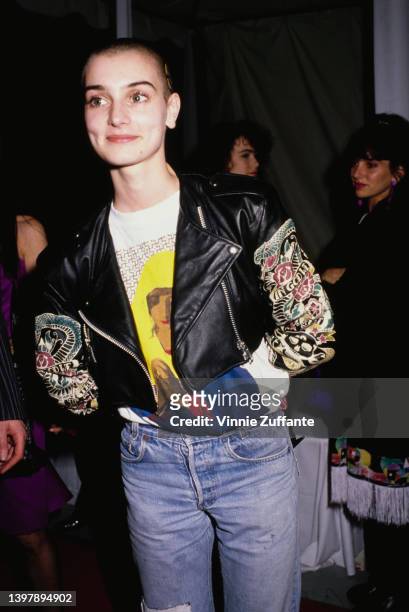 Irish singer-songwriter Sinead O'Connor, wearing a black leather jacket over a t-shirt with an image of a praying Virgin Mary, attends the 31st...