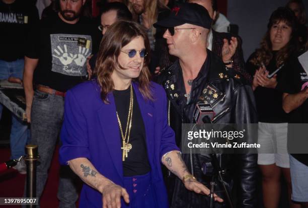 British singer and songwriter Ozzy Osbourne speaking with British singer and songwriter Rob Halford as the original line-up of Black Sabbath is...