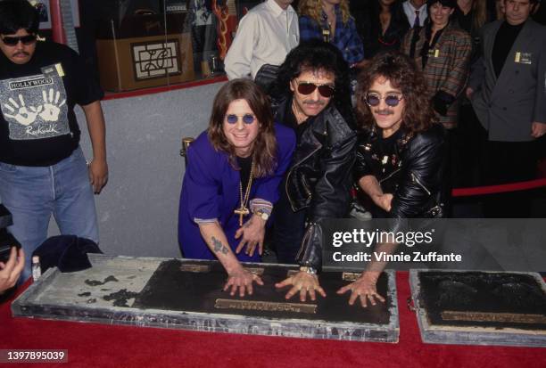 British singer and songwriter Ozzy Osbourne, British guitarist Tony Iommi, and British musician and songwriter Geezer Butler leaves their handprints...