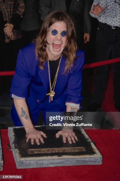 British singer and songwriter Ozzy Osbourne leaves his handprints as the original line-up of Black Sabbath is inducted into the RockWalk of Fame, at...