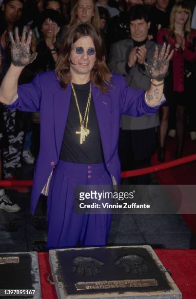 British singer and songwriter Ozzy Osbourne leaves his handprints as the original line-up of Black Sabbath is inducted into the RockWalk of Fame, at...