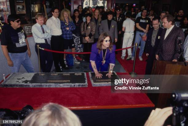 British singer and songwriter Ozzy Osbourne leaves his handprints as the original line-up of Black Sabbath is inducted into the RockWalk of Fame, at...