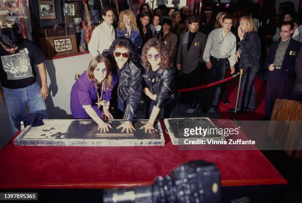 British singer and songwriter Ozzy Osbourne, British guitarist Tony Iommi, and British musician and songwriter Geezer Butler leaves their handprints...