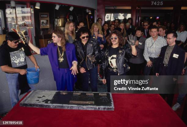 British singer and songwriter Ozzy Osbourne, British guitarist Tony Iommi, and British musician and songwriter Geezer Butler leaves their handprints...