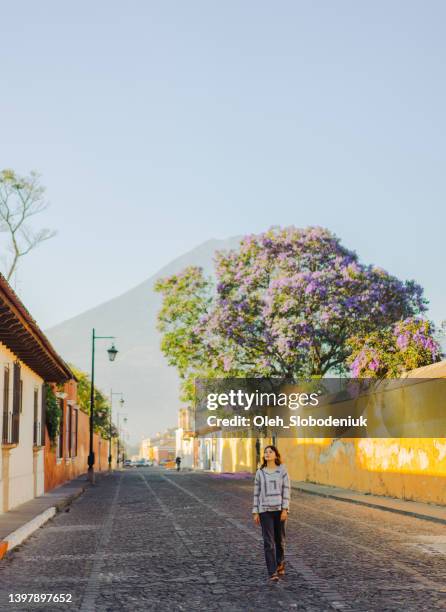 woman walking in antigua - guatemala city skyline stock pictures, royalty-free photos & images