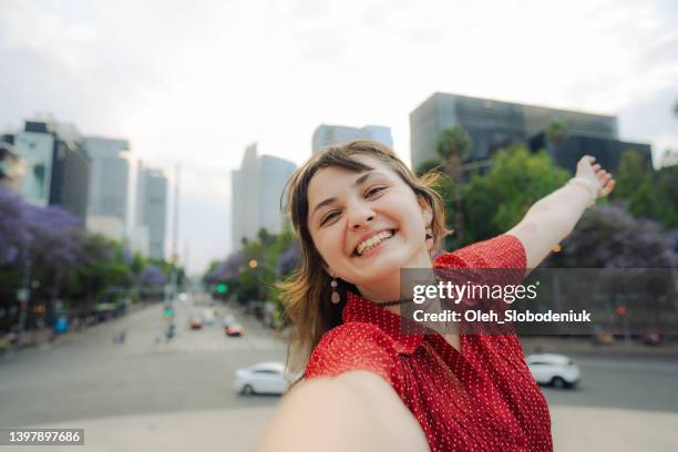 woman making selfie on the background of mexico cityscape - mexico city tourist stock pictures, royalty-free photos & images