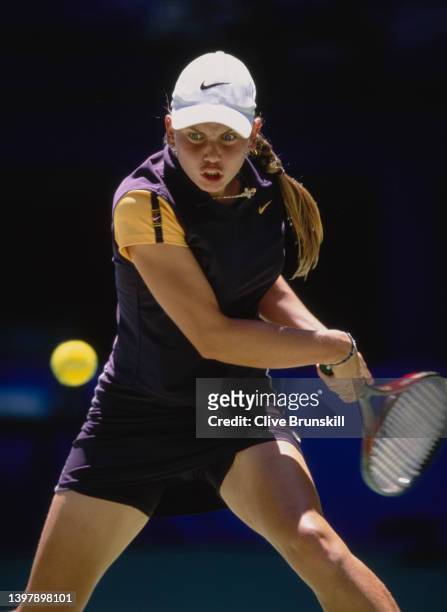Jelena Dokic from Australia watches the tennis ball as she plays a double handed backhand return to Martina Hingis of Switzerland during their...