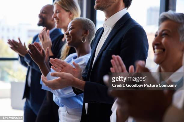 diverse businesspeople smiling and clapping after a presentation in a boardroom - awards ceremony stock pictures, royalty-free photos & images