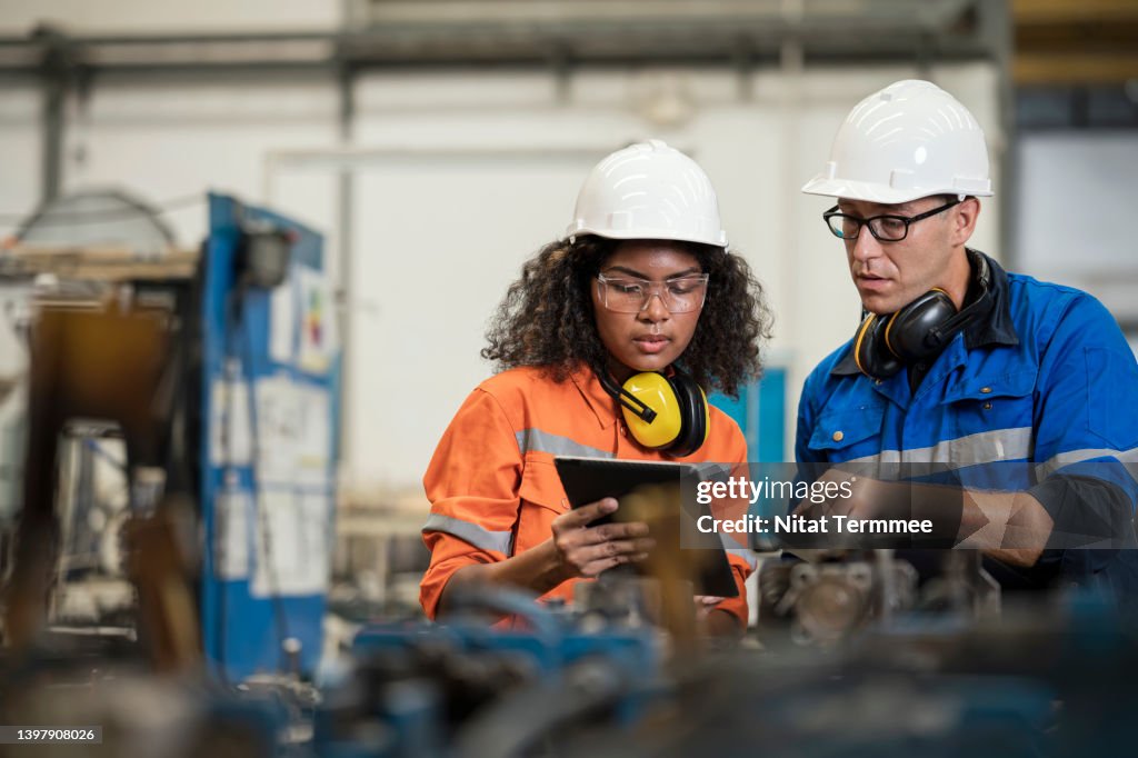 Productivity Improvement of Welding Assembly Lines in Manufacturing Industry. Manufacturing Process Engineers having discussion on welding jig design data to improve and reduce defect loss of work piece in welding process.