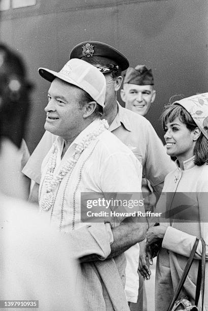 British-born American comedian & media personality Bob Hope arrives at Clark Air Base, Luzon, Philippines, December 28, 1967. Visible behind him is...