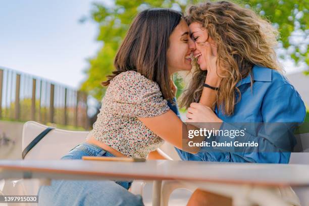 a proud couple, gay pride, couple of girls enjoying life, portraits - bi annual stock-fotos und bilder