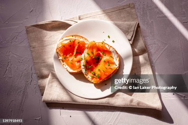 littlebourne, kent, england, uk. 12 may 2022. freshly baked sliced bagels. - chewy stock pictures, royalty-free photos & images