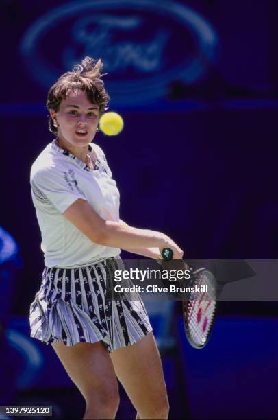 Martina Hingis of Switzerland plays a double handed backhand return to Mary Pierce of France in the Women's Singles Final match at the Australian...