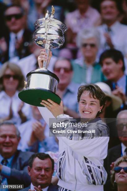 Martina Hingis of Switzerland holds the Daphne Akhurst Memorial Cup aloft after defeating Mary Pierce of France in the Women's Singles Final match at...