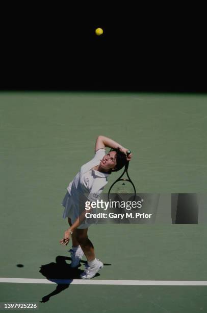 Martina Hingis from Switzerland reaches to serve to Conchita Martínez of Spain during their Women's Singles Final match at the Australian Open Tennis...