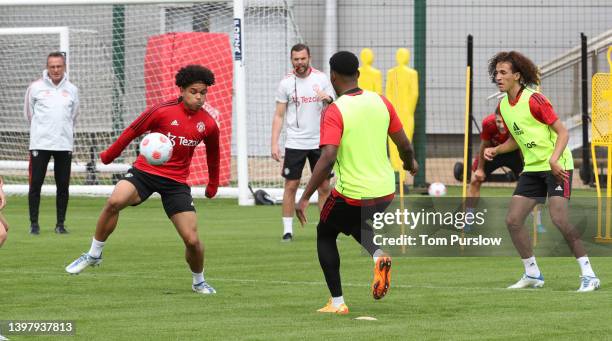 Shola Shoretire and Hannibal Mejbri of Manchester United in action during a first team training session at Carrington Training Ground on May 17, 2022...