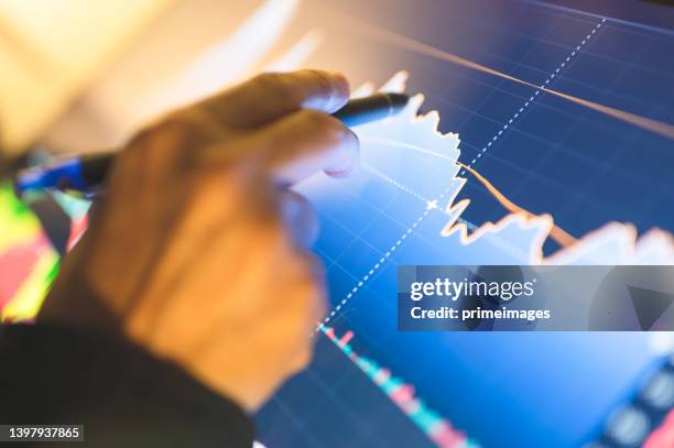 close-up businessmanr select stock and trade with graph/chart with fundamental  trading business concept. financial  cryptocurrency,bitcoin,digital asset - volatility stock pictures, royalty-free photos & images