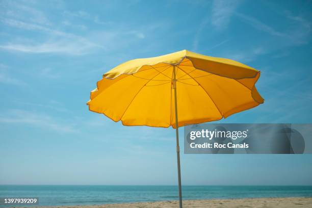 parasol - beach umbrella sand stock pictures, royalty-free photos & images