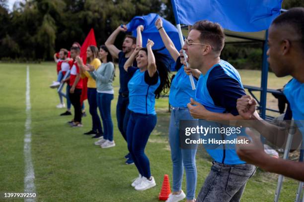 happy soccer fans cheering for their teams - reserve athlete stock pictures, royalty-free photos & images