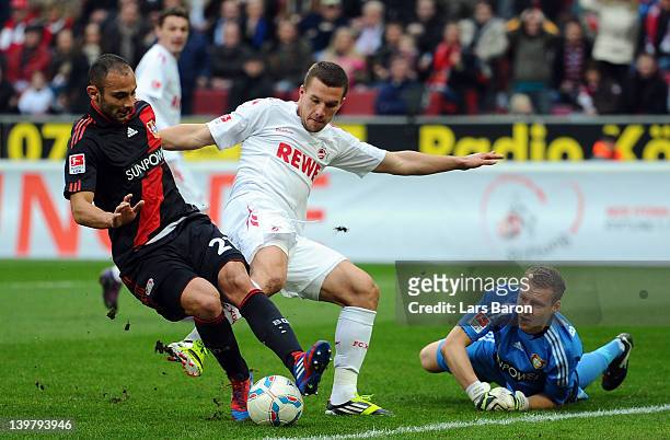 Oemer Toprak of Leverkusen is challenged by Lukas Podolski of Koeln during the Bundesliga match between 1. FC Koeln and Bayer 04 Leverkusen at...