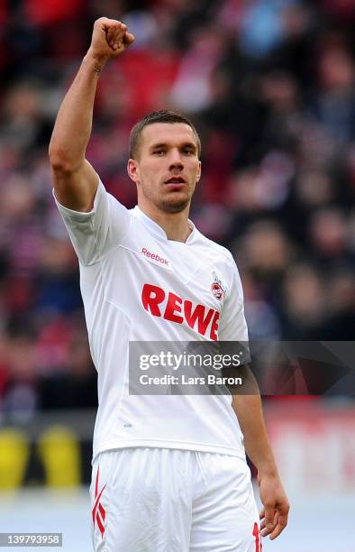 Lukas Podolski of Koeln gestures infront of the Leverkusen fans during the Bundesliga match between 1. FC Koeln and Bayer 04 Leverkusen at...