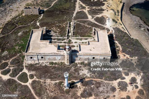 Aerial view, from a helicopter, The old lighthouse on the island of Correnti was a military structure, inhabited until a few decades ago by the...