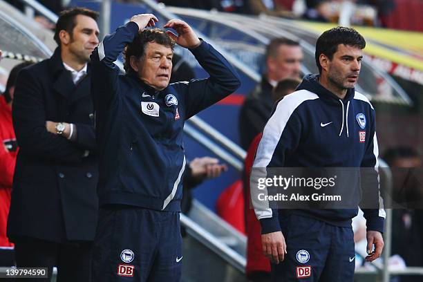 Head coach Otto Rehhagel , assistant coach Rene Tretschok and manager Michael Preetz of Berlin react during the Bundesliga match between FC Augsburg...