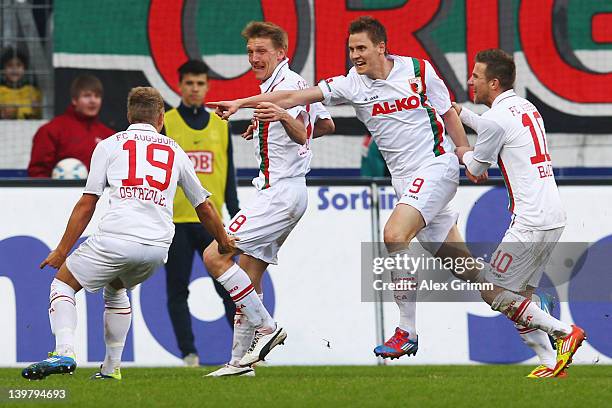 Thorsten Oehrl of Augsburg celebrates his team's second goal with team mates Matthias Ostrzolek, Axel Bellinghausen and Daniel Baier during the...