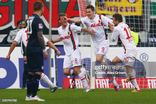 Thorsten Oehrl of Augsburg celebrates his team's second goal with team mates Matthias Ostrzolek, Axel Bellinghausen and Daniel Baier as Patrick Ebert...