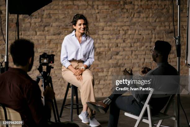 journalist interviewing a young woman in a studio - audition bildbanksfoton och bilder