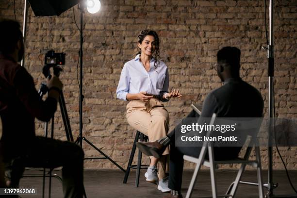 giving an interview in a modest studio - television set imagens e fotografias de stock