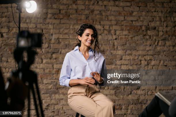 young woman giving an interview in a studio - casting actor stock pictures, royalty-free photos & images