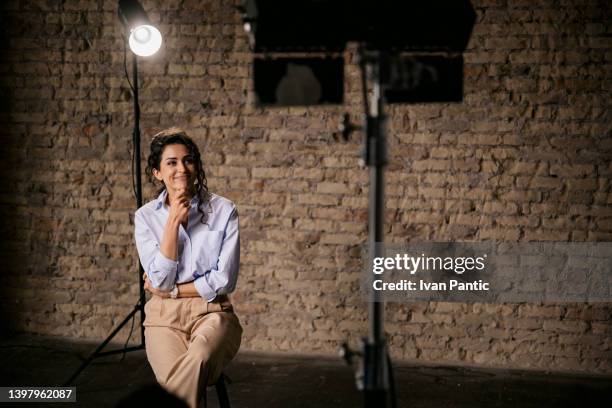 young woman giving an interview in a studio - pesca de lançamento imagens e fotografias de stock