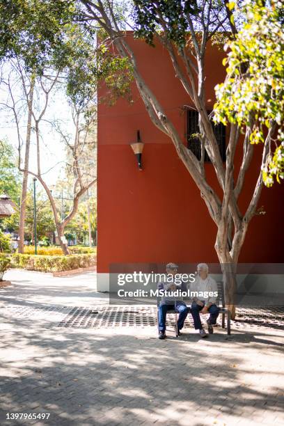 two senior men sitting on the bench - retirement community stock pictures, royalty-free photos & images