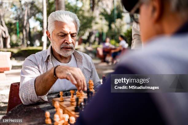 senior friends playing chess - senior playing chess stock pictures, royalty-free photos & images