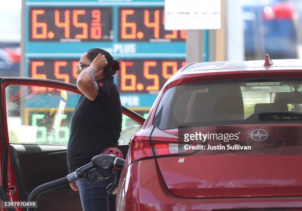 Customer pumps gas into their car at a gas station on May 18, 2022 in Petaluma, California. Gas prices in California have surpassed $6.00 per gallon...