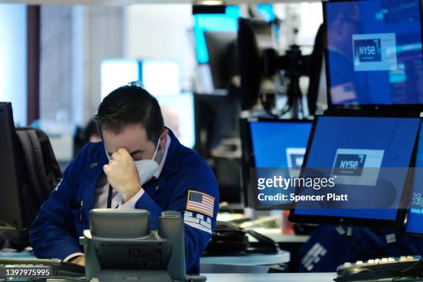 Traders work on the floor of the New York Stock Exchange on May 18, 2022 in New York City. The Dow Jones Industrial Average fell over 1000 points as...