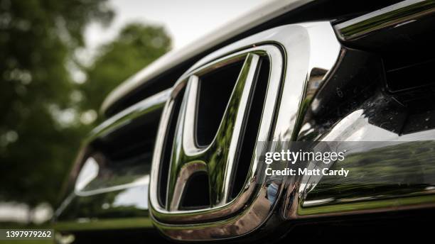 The logo of the car maker Honda is seen on the grille of a Honda CRV, on May 8, 2022 in Bristol, England. The Japanese car maker, which has been the...