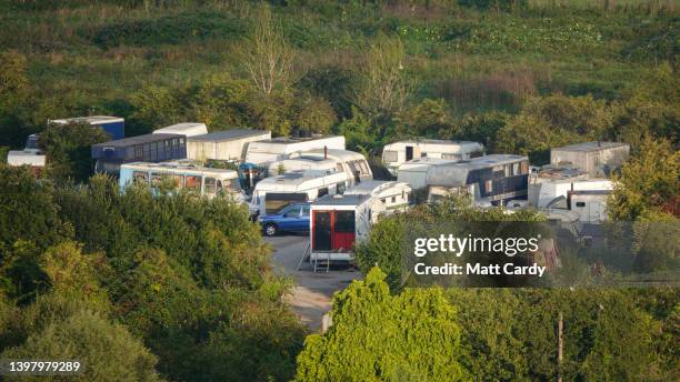 Vehicles and caravans are parked at a unauthorised traveller encampment , on May 15, 2022 in Glastonbury, England. The UK is currently facing a cost...
