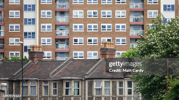 Windows in a 1960s block of flats overlook a terrace of houses, on May 15, 2022 in Bristol, England. The UK is currently facing a cost of living...