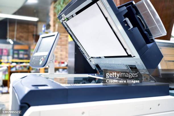 view of a modern photocopier printer machine in a workplace office. business, office supplies and technology concept. - fotocopiadora - fotografias e filmes do acervo